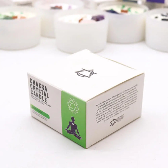 White cardboard box with green accents and black text for chakra crystal candle featuring a meditating figure silhouette