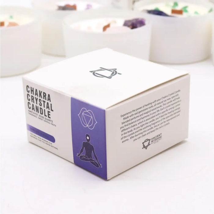 White cardboard box with purple accents labeled chakra crystal candle by ancient wisdom for third eye chakra use