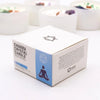 White cardboard box for throat chakra crystal candle with blue accents and black meditating figure graphics