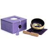 Dark blue chakra singing bowl with gold rim and lotus design for crown chakra, paired with a wooden mallet