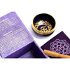 A dark blue chakra singing bowl with a gold rim and intricate mandala design for crown chakra sound healing