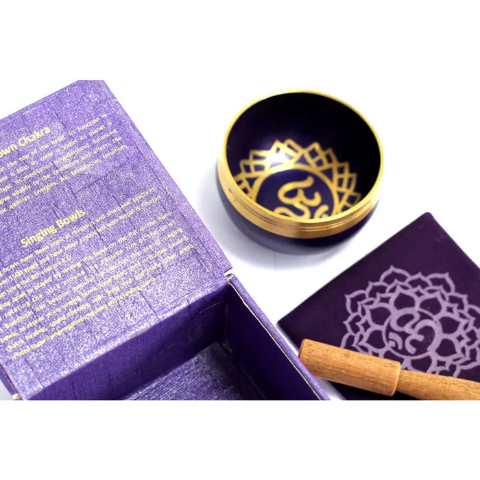 A dark blue chakra singing bowl with a gold rim and intricate mandala design for crown chakra sound healing