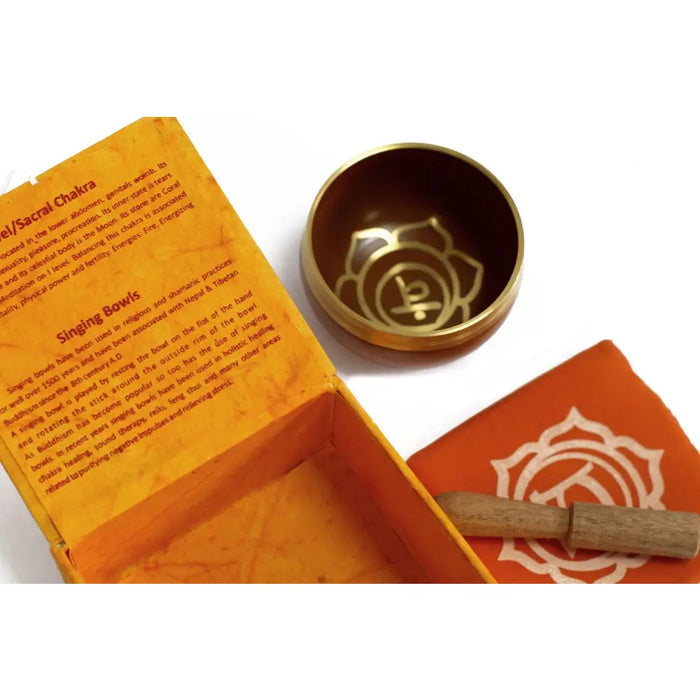 Golden brass chakra singing bowl with engraved lotus and sacral chakra symbol for chakra singing use