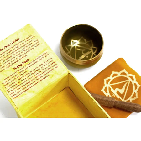 Golden brass chakra singing bowl with detailed solar plexus chakra symbol etched inside for meditation use