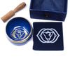 Deep blue chakra singing bowl with gold rim and silver om symbol for the third eye chakra meditation and healing