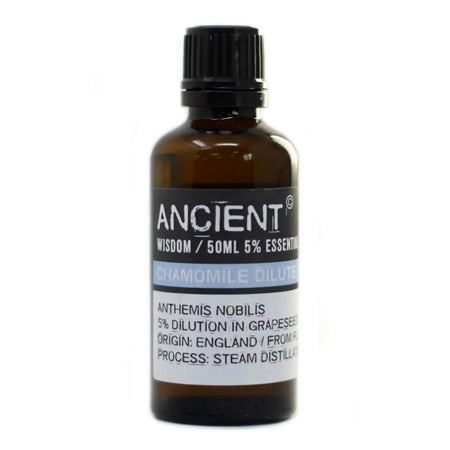 A dark amber glass bottle of roman chamomile essential oil 50ml with a black cap and allergen declarations label