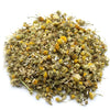 A pile of dried chamomile heads with yellow centers pale greenish-white petals and delicate stems in 1kg quantity