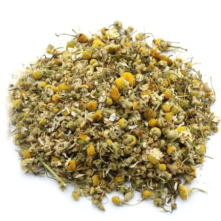 A pile of dried chamomile heads with yellow centers pale greenish-white petals and delicate stems in 1kg quantity