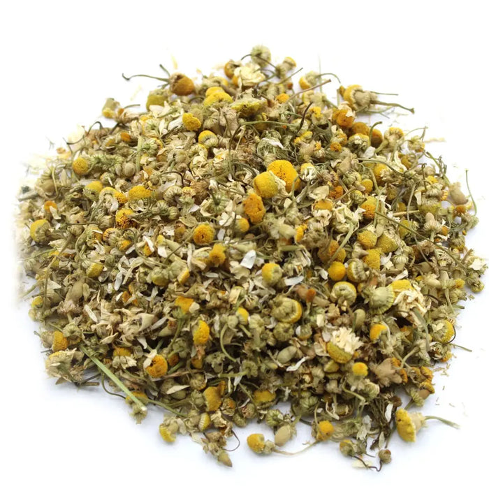 A pile of dried chamomile heads with yellow centers pale greenish-white petals and delicate stems in 1kg quantity