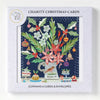 A christmas card pack by sarah battle with red and white floral bouquet and ornaments in a textured white box