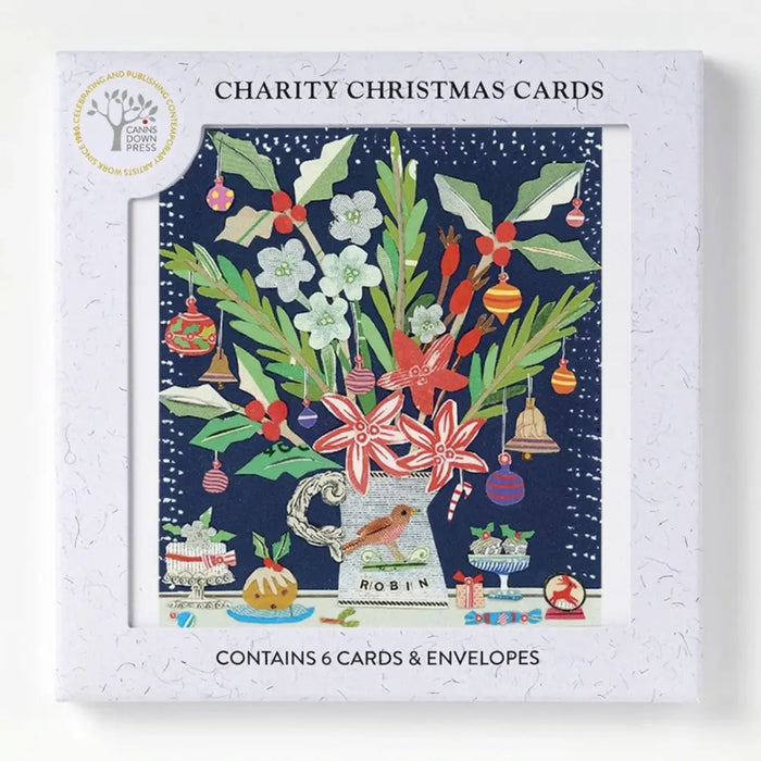 A christmas card pack by sarah battle with red and white floral bouquet and ornaments in a textured white box
