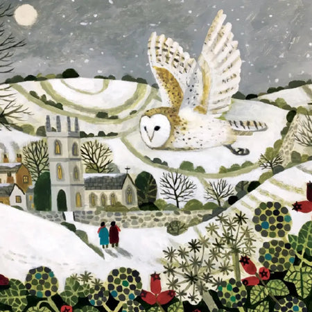 A white and brown snowy owl with outstretched wings flies over a snowy village on a charity christmas card by sarah bowman