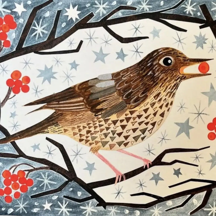 A christmas card pack featuring a brown song thrush with a speckled breast holding a red berry on snowy branches