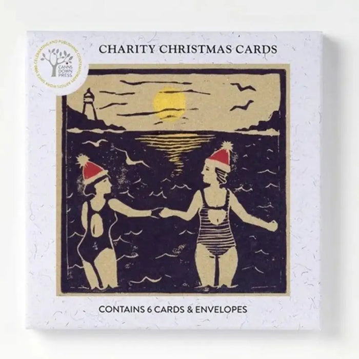 A bronwen tyrrell christmas card pack featuring a vintage black and gold card of two women in swimsuits by the sea