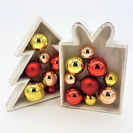 White wooden christmas tree and gift box decor with shiny red gold and rose-gold baubles in two designs