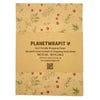 Beige recycled kraft wrapping paper with green leaf and red berry botanical pattern folded as a gift sheet