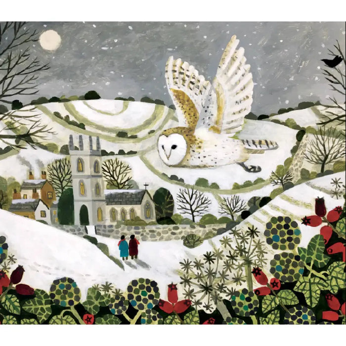 A snowy owl with white and brown feathers soars over a snowy village on a christmas cards pack by sarah bowman