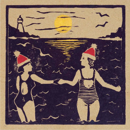 Vintage woodcut style christmas card pack showing two women in swimsuits with red santa hats by the ocean