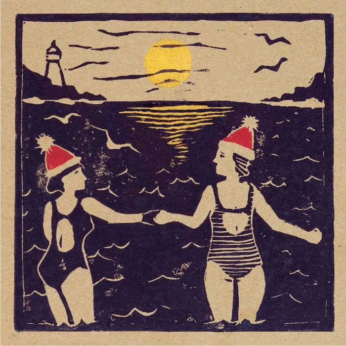 Vintage woodcut style christmas card pack showing two women in swimsuits with red santa hats by the ocean