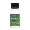 A clear glass bottle with black ribbed cap and green label of christmas garland fragrance oil with allergen declarations