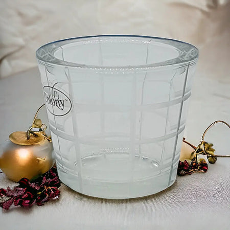 Clear chunky glass tealight holder with frosted etched diamond grid pattern and colony brand logo