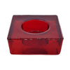 Chunky glass tealight holder in vibrant red with a square base and circular center made of translucent glass