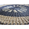 Handcrafted circular seagrass rug with dark gray and beige woven radial patterns made from natural fiber