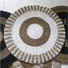 Circular seagrass rug with concentric rings of white and natural brown fibers made from woven seagrass