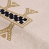 Beige canvas tote bag with embroidered deer antlers in tan and black thread alongside a cotton cushion cover