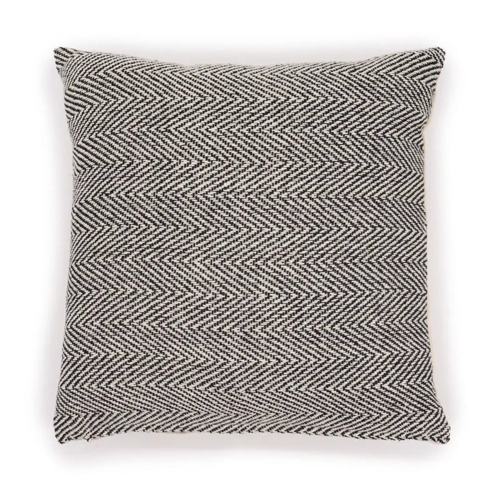 A square cotton cushion cover with a black and white fine herringbone weave pattern in grey tones