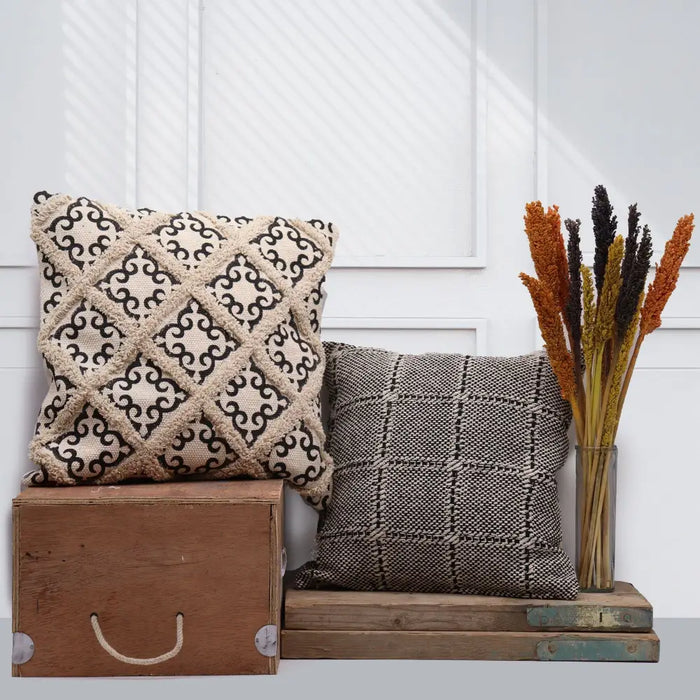Cream cotton cushion cover with black embroidered swirls and frayed edges in a classic cotton cushion style