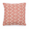 A soft coral cotton cushion with an off-white woven zig-zag geometric pattern and textured fabric cover