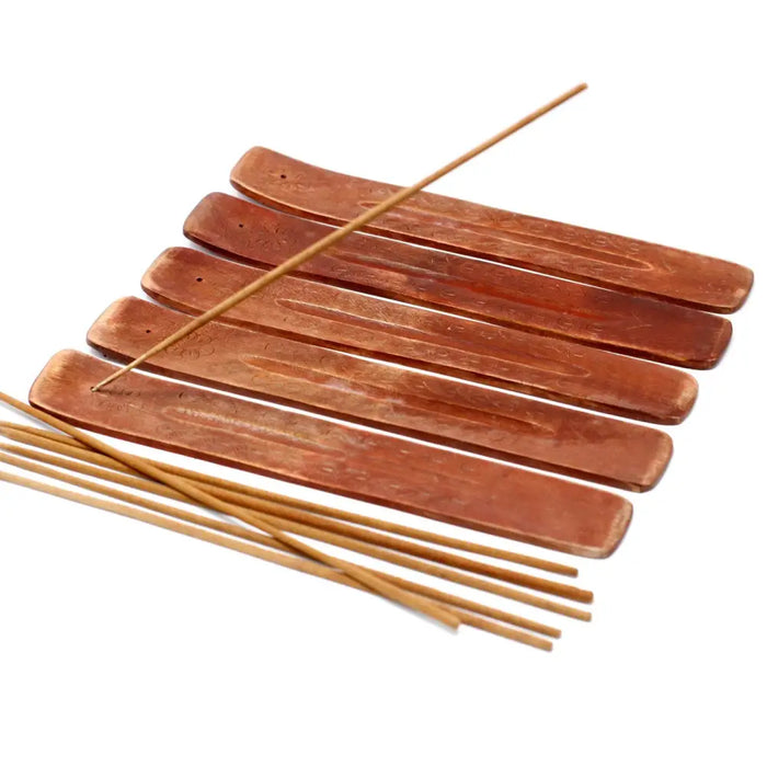 Set of six copper-colored mango wood ashcatchers with carved designs and matching light brown incense sticks