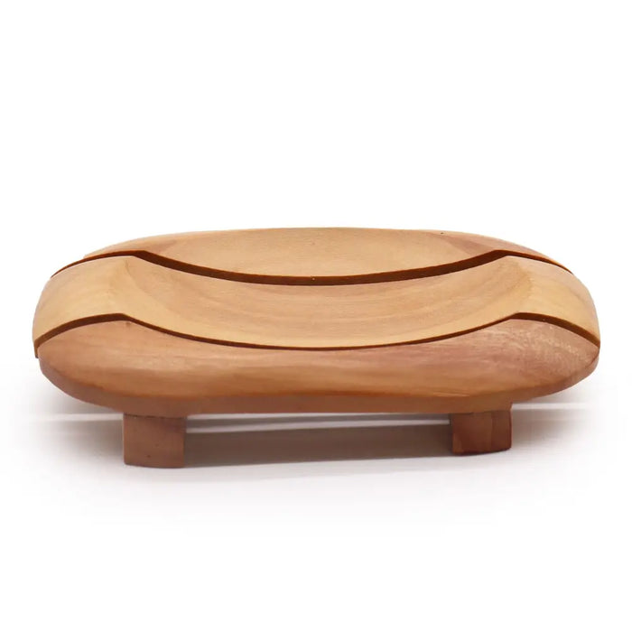 Light brown naseberry wood soap dish with smooth curved oval design and two small feet for bathroom use