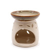 Cream-colored ceramic oil burner with glazed top rim and leaf-shaped cutouts in a natural style design