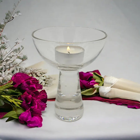 Clear glass ball candle and tealight holder with a wide bowl top and slender stem made of transparent glass