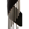 Silver toned metal wind chimes with a sleek modern design hang from a dark curved canopy in coconut leaf style