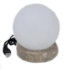 A sleek frosted white himalayan salt lamp ball with a textured beige stone base and black usb crystal rock cable