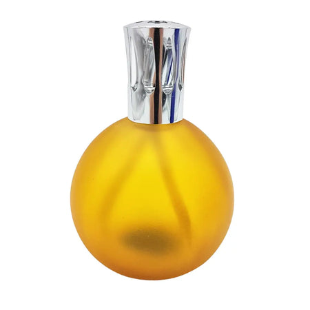 A sleek amber coloured glass fragrance lamp with a chrome ridged cap for colony perfume lamps and lamp oil use