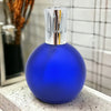 A cobalt matte blue glass fragrance lamp with polished chrome top featuring vertical cutouts for lamp oil use