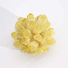 A cluster of translucent yellow natural quartz with faceted geometric shapes in a coloured quartz cluster display