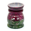 A hand-carved coloured soapstone oil burner with purple and green tones featuring om symbol and elephant designs