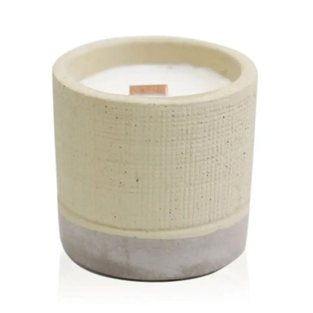 Beige and gray textured concrete candle pot with white wax candle and wooden wick for coffee in the club vibe