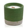 Green concrete candle pot with white wax interior and wooden wick in sea moss and herbs scent