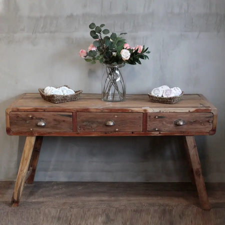 Rustic wooden console table with three drawers metal pulls and angled legs made from recycled wood