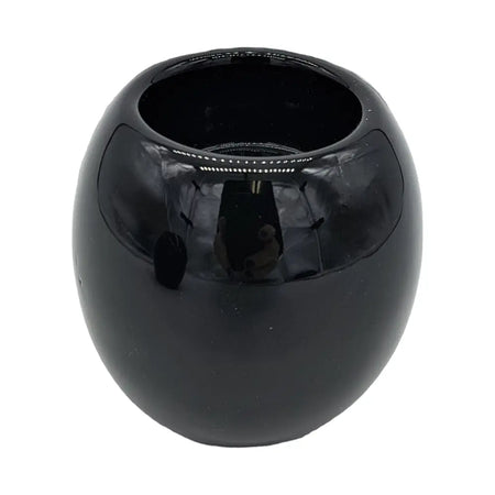 A sleek black ceramic tealight holder with a rounded bowl shape and smooth glossy surface
