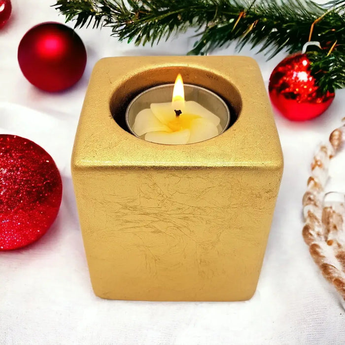 Gold metallic ceramic tealight holder with lit white tea light inside 5cm square contemporary design