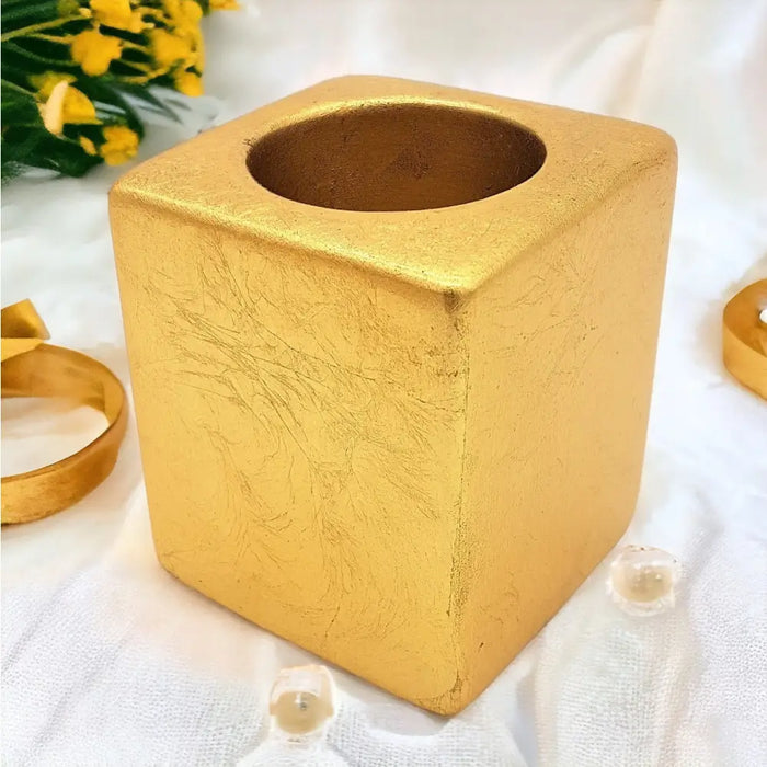 Gold square ceramic tealight holder with 5cm square dimensions and textured leaf patterns on a matte finish