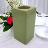 A matte sage green ceramic tealight holder with a square shape and rounded edges high x 7cm size