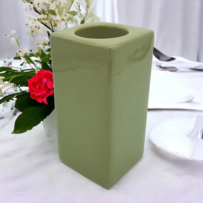 A matte sage green ceramic tealight holder with a square shape and rounded edges high x 7cm size